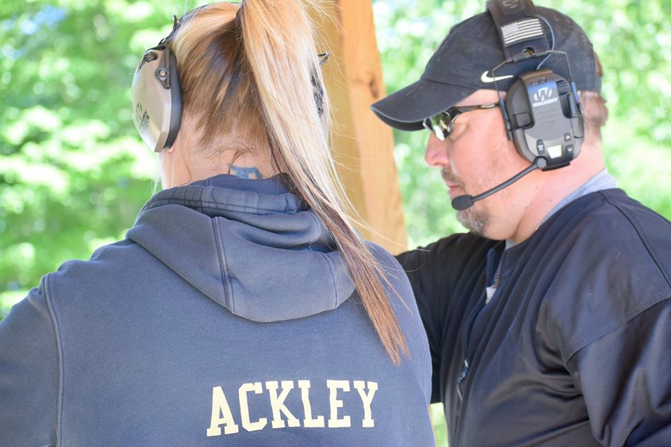 A Creekside Consultants instructor coaching a student on the line at the Clayton range