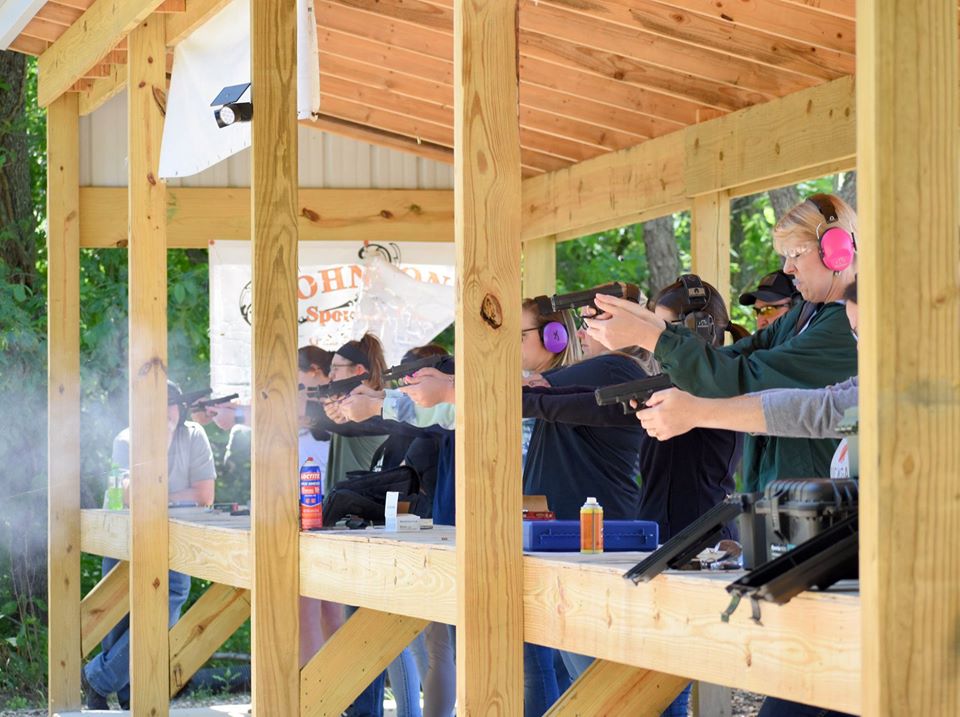 Students on the firing line under the covered outdoor range at Creekside Consultants in Clayton, Michigan